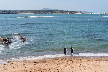 Two friends go surfing in the bay of Saint Jean de Luz