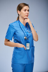 Wall Mural - Serious thinking doctor or nurse woman looking away. Isolated female portrait.