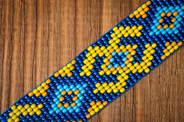 Chokers made of braided beads of blue-yellow color with Ukrainian folk patterns.