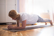 © Viktor Koldunov - Exercising At Home. Sporty caucasian woman ng yoga plank