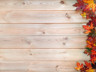 Wall Mural - Variegated fallen leaves on wooden background. Thematic content. Flat lay. Copyspace for text. Lots of maple leaves on right on tabletop. Top view. Concept of autumn holidays and festivals