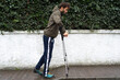 © Tessy Morelli/Stocksy - Carefully taking the first walk steps with crutches after injury
