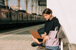 © Olga Moreira/Stocksy - Female student working on laptop on the train station