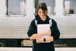 © Olga Moreira/Stocksy - Young smiling student with laptop on the train station
