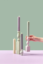 Candles With Holders In Woman's Hand.