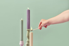 Handmade Candles Being Lit By Woman's Hand.