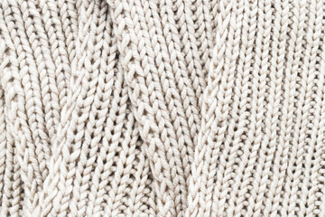 knitting. vertical striped beige knit fabric texture, knitted pattern background. top view
