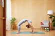 © ALTO IMAGES/Stocksy - Fit woman doing Wheel pose