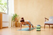 © ALTO IMAGES/Stocksy - Slim woman doing Chaturanga Dandasana posture