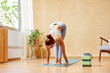 © ALTO IMAGES/Stocksy - Flexible woman practicing yoga at home