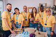 © Zamrznuti tonovi - Group of multiracial volunteers working in community charity donation center