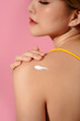 © Marc Tran/Stocksy - Beauty fashion, young woman apply cream on her body