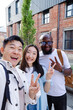 © Oleksii Syrotkin/Stocksy - Friends taking selfie with V sign