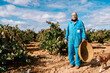 © Ezequiel Giménez/Stocksy - Senior farmer with dog near grapevines
