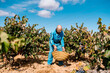 © Ezequiel Giménez/Stocksy - Senior farmer putting basket on ground