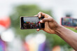 © Leonardo Borges/Stocksy - Recording with a cell phone at the lgbt march.