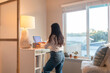 © ByLorena/Stocksy - Woman at standing desk working remote from home