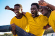 © Vane Nunes - Crazy black football fans celebrating in the crowd while watching the game at sport stadium - Soccer supporters screaming for their team during world champion event - Focus on center African man face