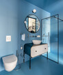© Andriy Bezuglov/Stocksy - Modern blue walls bathroom interior with white shelf and white sink