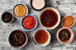 © Dina Ávila/Stocksy - Various Dipping Sauces in a Variety of Stoneware Bowls