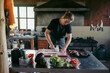 © Luis Herrera/Stocksy - woman chef at her small business kitchen