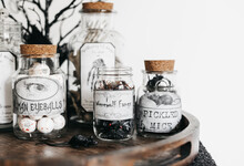 Creepy Halloween Decor In Homemade Jars On A Nightstand. 
