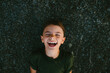 © Maria Manco/Stocksy - Overhead view of young girl laughing on the beach