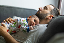 Sleeping Father With His Baby On The Sofa