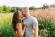 © Serena Burroughs/Stocksy - Happy married couple in field on a summer day