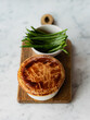 © Andrew Urwin/Stocksy - A pie crust being broken and eaten with a spoon.
