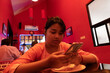 © Dream Lover/Stocksy - Indian teenage girl browsing smartphone inside a restaurant