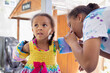 © anya brewley schultheiss/Stocksy - Teenager getting a young child ready for the pool