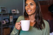 © Manu Prats/Stocksy - Authentic woman having coffe and looking out the window