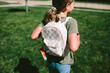 © Maria Manco/Stocksy - girl in ponytail wearing a backpack