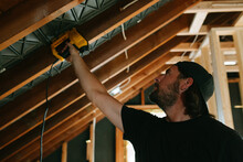 Man Uses Nail Gun In Construction Home