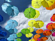 © Raymond Forbes LLC/Stocksy - Colorful Umbrella Sunshade outdoors in summer with cloud at street