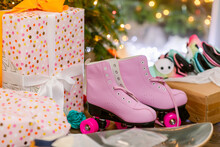 Skates And Gifts Under The Tree At Christmas