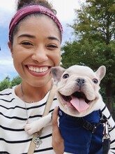 A Mobile Selfie Of A Woman Holding A Puppy
