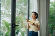 © Marc Tran/Stocksy - Young business woman eating salad at office, having healthy lunch