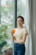 © Marc Tran/Stocksy - Young beautiful woman drinking juice