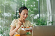 © Marc Tran/Stocksy - Pretty Female Employee Having Lunch in Office, Woman Eating Salad