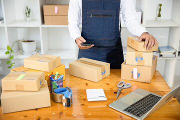 Starting small businesses SME owners man entrepreneurs working, box and check online orders to prepare to pack the boxes, sell to customers, sme business ideas online.