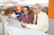 © G-images - Senior businessman with woman using laptop at office.