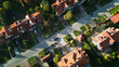 Aerial view of the city suburb. Family houses and green areas and gardens. Avenues and streets. Living in the countryside and suburbs close to the big city. 