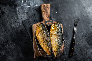 Wall Mural - Grilled mackerel fish fillet on a grill. Black background. Top view