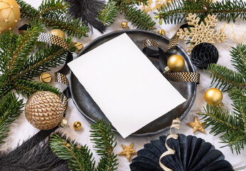 Black and golden Christmas Table setting with ornaments and fir tree branches. Menu card Mockup