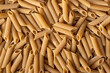 Uncooked whole grain pasta. Raw penne pasta. Top view.