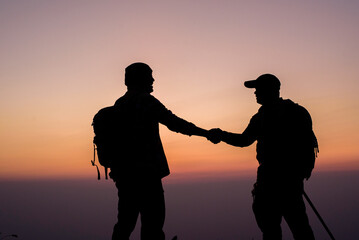 Silhouette of Teamwork helping hand trust help