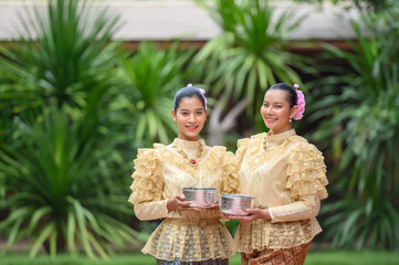 Wall Mural - Portrait beautiful women in Songkran festival with Thai Traditional costume