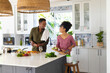 © Wavebreak Media - Happy african american couple cooking dinner together in kitchen